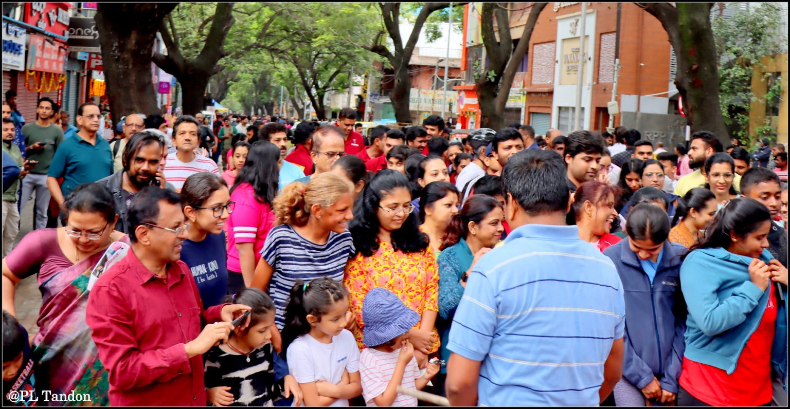 Un hombre hablando con una multitud en una calle de la ciudad