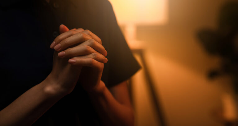 Hands clasped in prayer